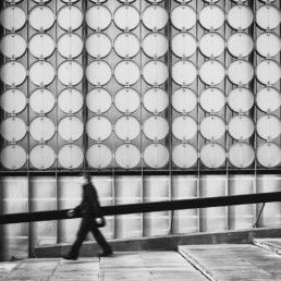 Man-walking-past-RMIT-building-in-Melbourne